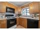 Well-equipped kitchen featuring modern appliances, light wooden cabinets, and tiled backsplash at 3616 W Morrison Ave, Tampa, FL 33629