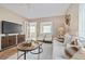 Cozy living room featuring comfortable seating, stylish decor, and a large entertainment center at 3616 W Morrison Ave, Tampa, FL 33629