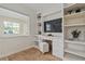 Office space with built-in shelving, a cozy stool, and a bright window at 3616 W Morrison Ave, Tampa, FL 33629