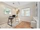 Home office featuring neutral tones, a glass desk, and ample natural light at 3616 W Morrison Ave, Tampa, FL 33629