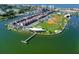 Scenic aerial view of waterfront properties with a nearby park and baseball fields at 169 Medallion Blvd # E, Madeira Beach, FL 33708