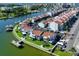 Aerial perspective of a coastal property, revealing townhomes, boat docks, and well-kept green spaces at 169 Medallion Blvd # E, Madeira Beach, FL 33708