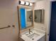 Bathroom with square sink, modern faucet, medicine cabinet, and decorative mirror at 169 Medallion Blvd # E, Madeira Beach, FL 33708