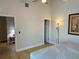 View of a bedroom with open doors, high ceilings and a flower picture on the wall at 169 Medallion Blvd # E, Madeira Beach, FL 33708