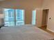 View of a bedroom with bed and a window that looks out to a blue building at 169 Medallion Blvd # E, Madeira Beach, FL 33708