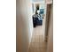 Hallway leading into living room with tile floors and a blue sofa with pillows at 169 Medallion Blvd # E, Madeira Beach, FL 33708