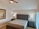 Main bedroom with gray furniture, mattress, and two side tables with lamps at 169 Medallion Blvd # E, Madeira Beach, FL 33708