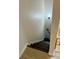 Staircase with wooden steps going down with a wooden handrail at 169 Medallion Blvd # E, Madeira Beach, FL 33708