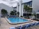 Inviting community pool surrounded by well-maintained landscaping and comfortable lounge chairs at 169 Medallion Blvd # E, Madeira Beach, FL 33708