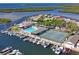 Aerial view featuring waterfront homes, a pool, tennis courts, and a marina at 4514 Dewey Dr, New Port Richey, FL 34652