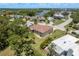 Spacious two-story home in a lush neighborhood with mature trees, near tranquil waters and a clear blue sky at 4514 Dewey Dr, New Port Richey, FL 34652