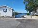 Coast Guard Auxiliary building with boat launch access in a beautiful waterfront setting with clear skies and green vegetation at 4514 Dewey Dr, New Port Richey, FL 34652