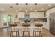 Bright kitchen features a center island, stainless steel appliances, stylish pendant lighting, and tile backsplash at 4514 Dewey Dr, New Port Richey, FL 34652