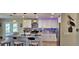 Modern kitchen with a breakfast bar, stainless steel appliances, stylish lighting, and tile backsplash at 4514 Dewey Dr, New Port Richey, FL 34652