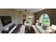 Bright living room with vaulted ceilings, decorative window, and comfortable furniture, creating a welcoming atmosphere at 4514 Dewey Dr, New Port Richey, FL 34652