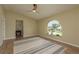 Bright living room featuring a ceiling fan and a large arched window offering pleasant views at 4514 Dewey Dr, New Port Richey, FL 34652