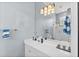Clean bathroom featuring a spacious vanity, modern lighting, and decorative tiling details at 4531 Swordfish Dr, Bradenton, FL 34208