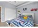 Bedroom featuring tiled floors, a striped bedspread, and a double door closet at 4531 Swordfish Dr, Bradenton, FL 34208