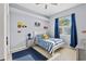 Bright bedroom with blue accents, a large window, and a playful decor at 4531 Swordfish Dr, Bradenton, FL 34208