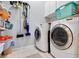 Well-organized laundry room with washer, dryer, utility sink and overhead cabinets at 4531 Swordfish Dr, Bradenton, FL 34208