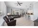Open-concept living room with tile floors, comfortable seating, a ceiling fan, and easy kitchen access at 4531 Swordfish Dr, Bradenton, FL 34208