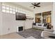 Relaxing screened-in patio area with a TV, fireplace, comfortable seating, and a stylish rug at 4531 Swordfish Dr, Bradenton, FL 34208