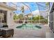 Inviting screened-in pool area featuring a kidney-shaped pool, hot tub, and comfortable patio furniture at 4531 Swordfish Dr, Bradenton, FL 34208