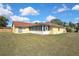 Spacious backyard with a screen-enclosed porch and a well-maintained lawn at 10412 Ireland St, Spring Hill, FL 34608