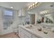 Bright bathroom featuring a long vanity with sink, mirror, and overhead lighting at 10412 Ireland St, Spring Hill, FL 34608