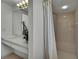 Bathroom with a shower, white shower curtain, and vanity with decorative floral arrangement at 10412 Ireland St, Spring Hill, FL 34608