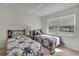 Bedroom featuring two beds, a nightstand, and a window for natural light at 10412 Ireland St, Spring Hill, FL 34608