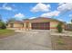 Charming single Gathering home featuring a two-car garage, peach accents and a well maintained front yard at 10412 Ireland St, Spring Hill, FL 34608