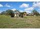 Charming single-story home with a well-maintained front yard featuring palm trees and green lawns at 10412 Ireland St, Spring Hill, FL 34608