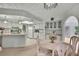 Cozy kitchen with white cabinets, island and eat-in dining area with chandelier at 10412 Ireland St, Spring Hill, FL 34608