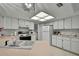 Functional kitchen featuring white cabinetry, laminate countertops, and modern appliances at 10412 Ireland St, Spring Hill, FL 34608