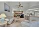 Open-concept living room with a stone fireplace and bar counter to the kitchen at 10412 Ireland St, Spring Hill, FL 34608