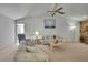 Bright living room with vaulted ceilings, ceiling fan, and comfortable seating arrangement at 10412 Ireland St, Spring Hill, FL 34608