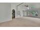 Open-concept living room with views of kitchen, dining area, and backyard access, offering seamless entertaining at 10412 Ireland St, Spring Hill, FL 34608