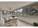 Inviting sunroom with tiled flooring, large windows, and a dining table with chairs at 10412 Ireland St, Spring Hill, FL 34608