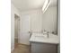 Bathroom with double sink vanity with white countertop, gray cabinets, and modern fixtures at 11594 Oak Ln, Largo, FL 33778