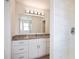 Bathroom vanity with granite countertops and a large mirror at 11594 Oak Ln, Largo, FL 33778