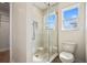Bathroom features a glass-enclosed shower with tiled walls and floors, plus a bright window at 11594 Oak Ln, Largo, FL 33778