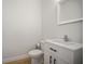 Powder room featuring a modern vanity with white countertop and cabinets, and black hardware at 11594 Oak Ln, Largo, FL 33778