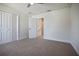 Carpeted bedroom featuring closet space and a door leading to the stairway at 11594 Oak Ln, Largo, FL 33778