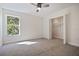 Carpeted bedroom with a closet, and a window allowing natural light at 11594 Oak Ln, Largo, FL 33778