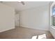 Comfortable bedroom with neutral walls, carpet, and a window letting in natural light at 11594 Oak Ln, Largo, FL 33778