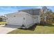 Charming two-story home with a two-car garage, landscaped front yard, and inviting walkway to the front door at 11594 Oak Ln, Largo, FL 33778