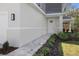 Close up of the home's front door and walkway, highlighting the home's landscaped yard at 11594 Oak Ln, Largo, FL 33778