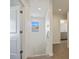 Upstairs hallway leads to the bedrooms and bathroom with plenty of natural light at 11594 Oak Ln, Largo, FL 33778