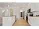 Well-equipped kitchen boasts stainless steel appliances, white cabinets, an island, and modern lighting at 11594 Oak Ln, Largo, FL 33778